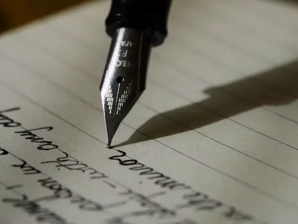 Handwritten manuscript pages beside a keyboard